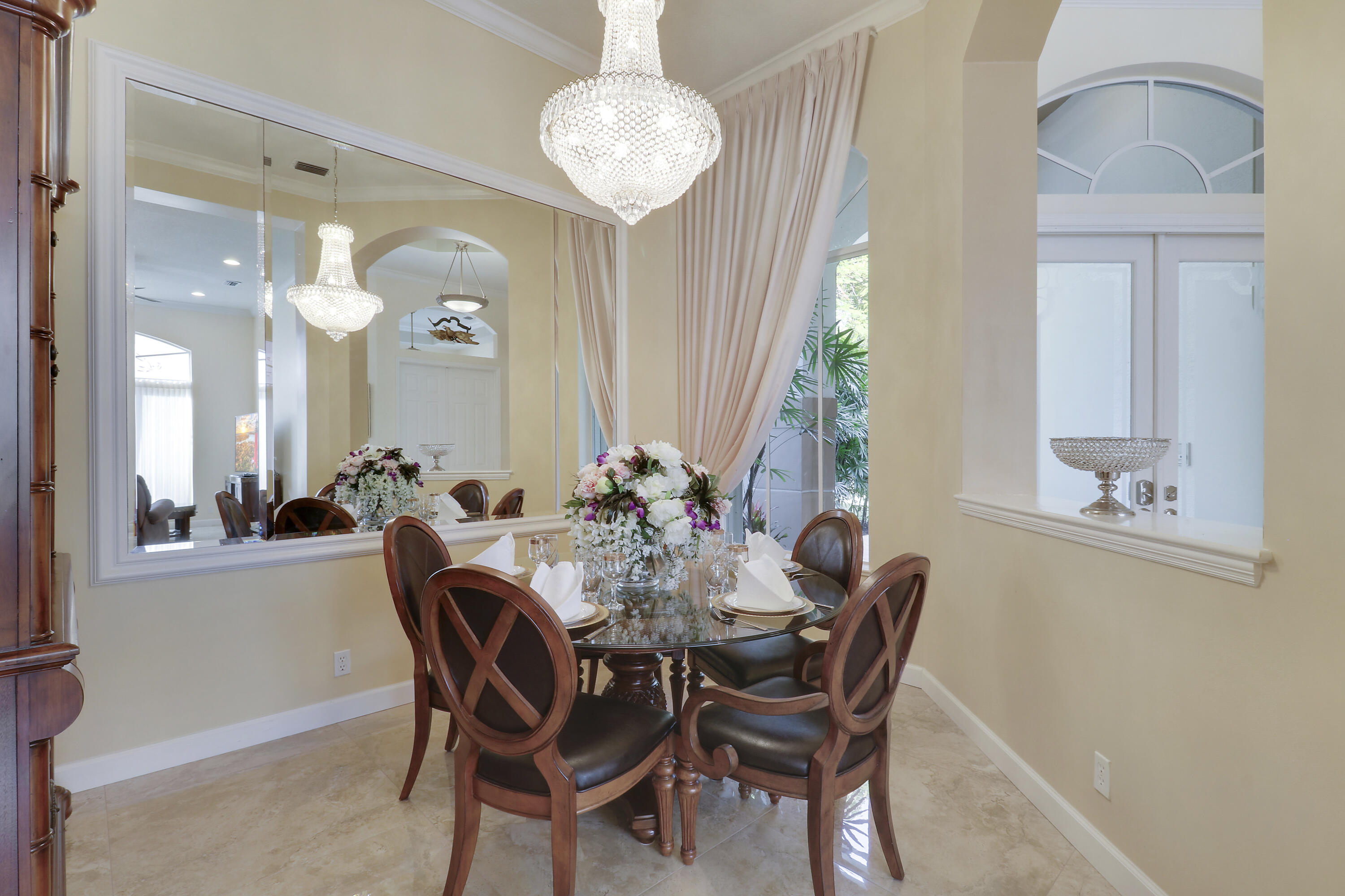 8216 Cypress Point Road West Palm Beach, FL 33412 - Photo 8 of 62 a view of a dining room with furniture and a chandelier