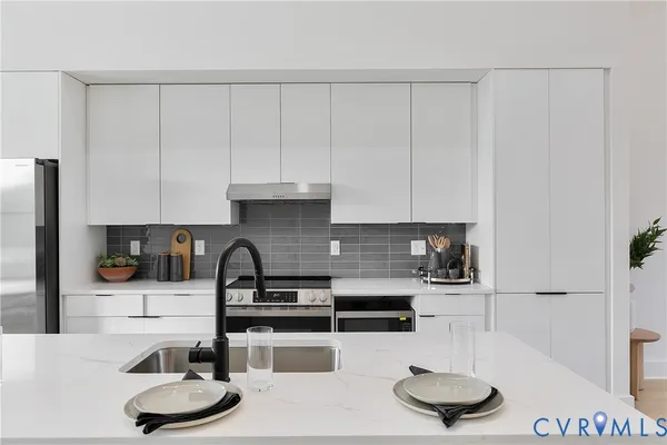 a kitchen with a table chairs and a stove