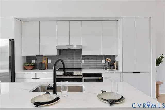 a kitchen with a table chairs and a stove