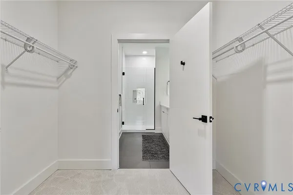 a bathroom with a double vanity sink a mirror and a shower