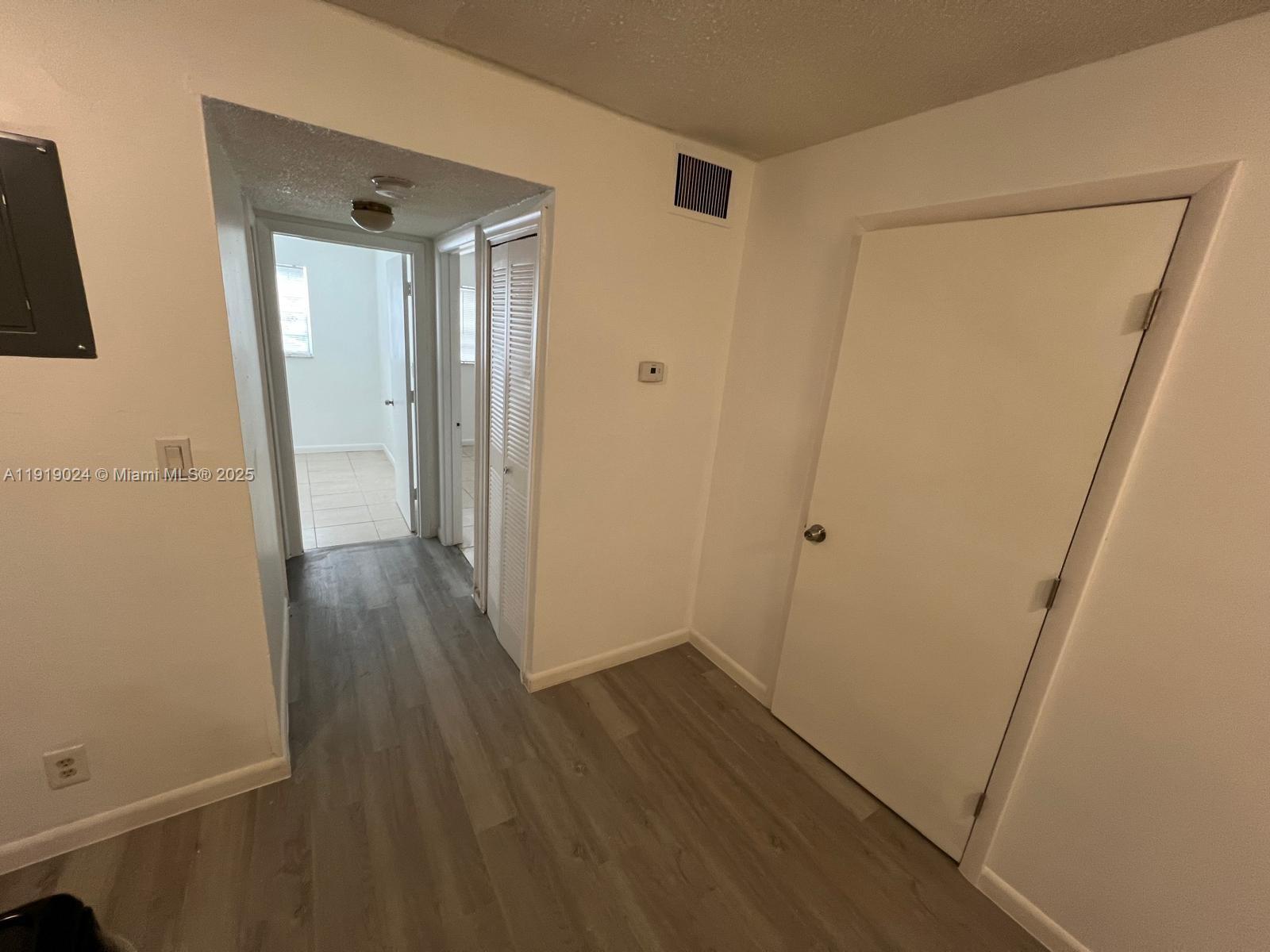 6840 Pembroke Road, Unit 112 Pembroke Pines, FL 33023 - Photo 2 of 5 a view of a hallway with wooden floor