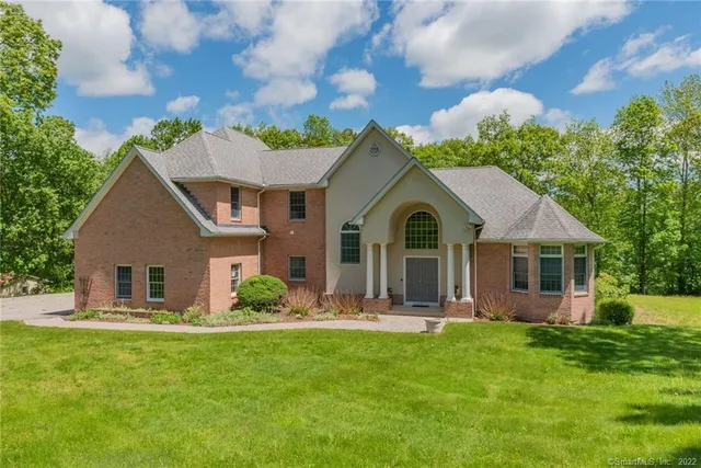 a front view of a house with a garden and plants