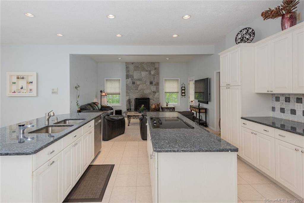 54 Bulkeley Hill Road Colchester, CT 06415 - Photo 11 of 40 a large kitchen with granite countertop a sink and white appliances