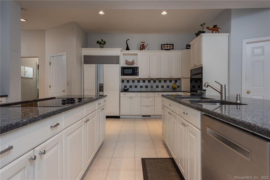 54 Bulkeley Hill Road Colchester, CT 06415 - Photo 13 of 40 a kitchen with stainless steel appliances granite countertop a sink and cabinets