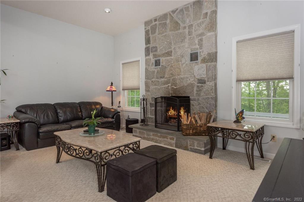 54 Bulkeley Hill Road Colchester, CT 06415 - Photo 15 of 40 a living room with furniture and a fireplace