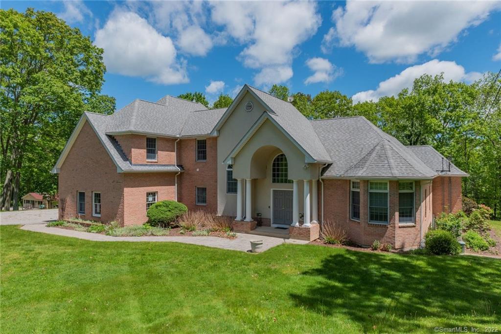 54 Bulkeley Hill Road Colchester, CT 06415 - Photo 2 of 40 a front view of a house with a yard