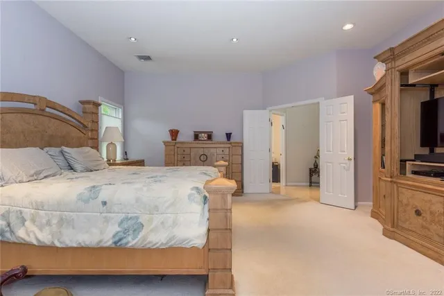 a bathroom with a granite countertop sink a large mirror and a shower