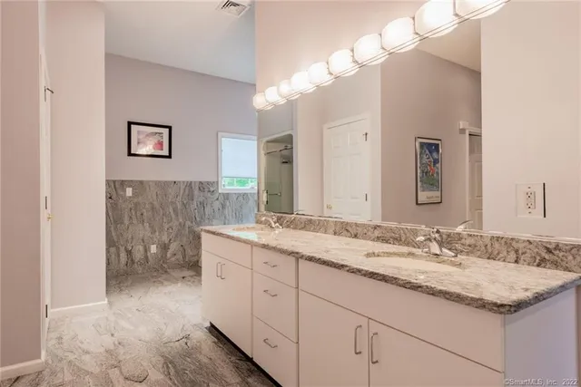 a bathroom with a tub a sink and a shower