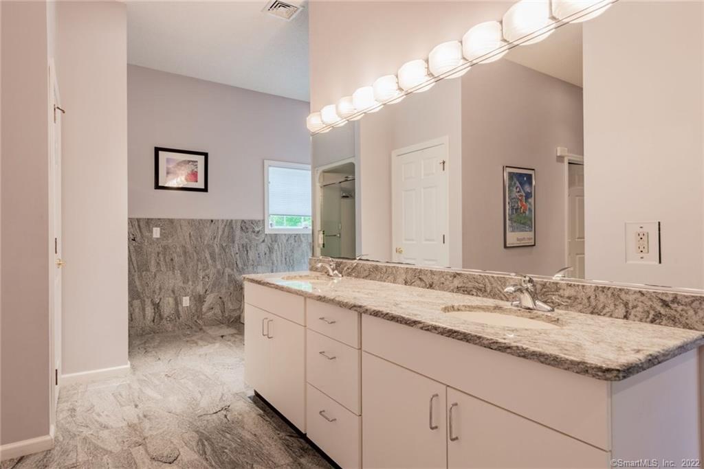 54 Bulkeley Hill Road Colchester, CT 06415 - Photo 28 of 40 a bathroom with a granite countertop sink a large mirror and a shower