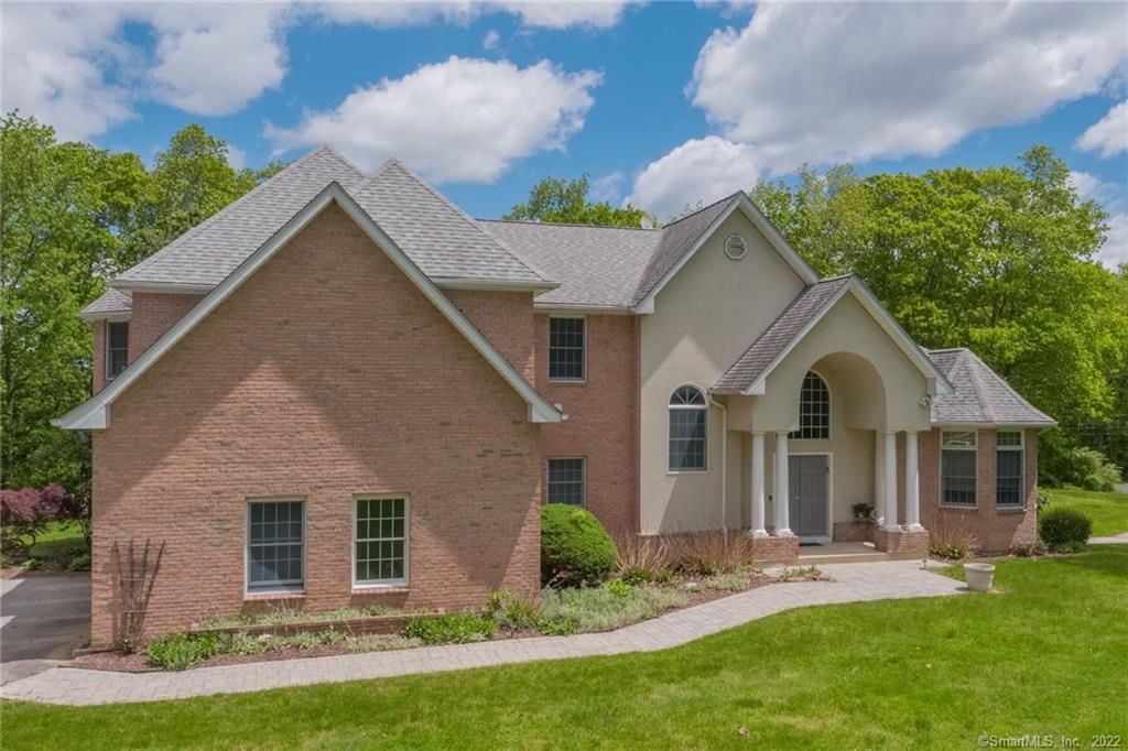 54 Bulkeley Hill Road Colchester, CT 06415 - Photo 3 of 40 a front view of a house with a yard and porch