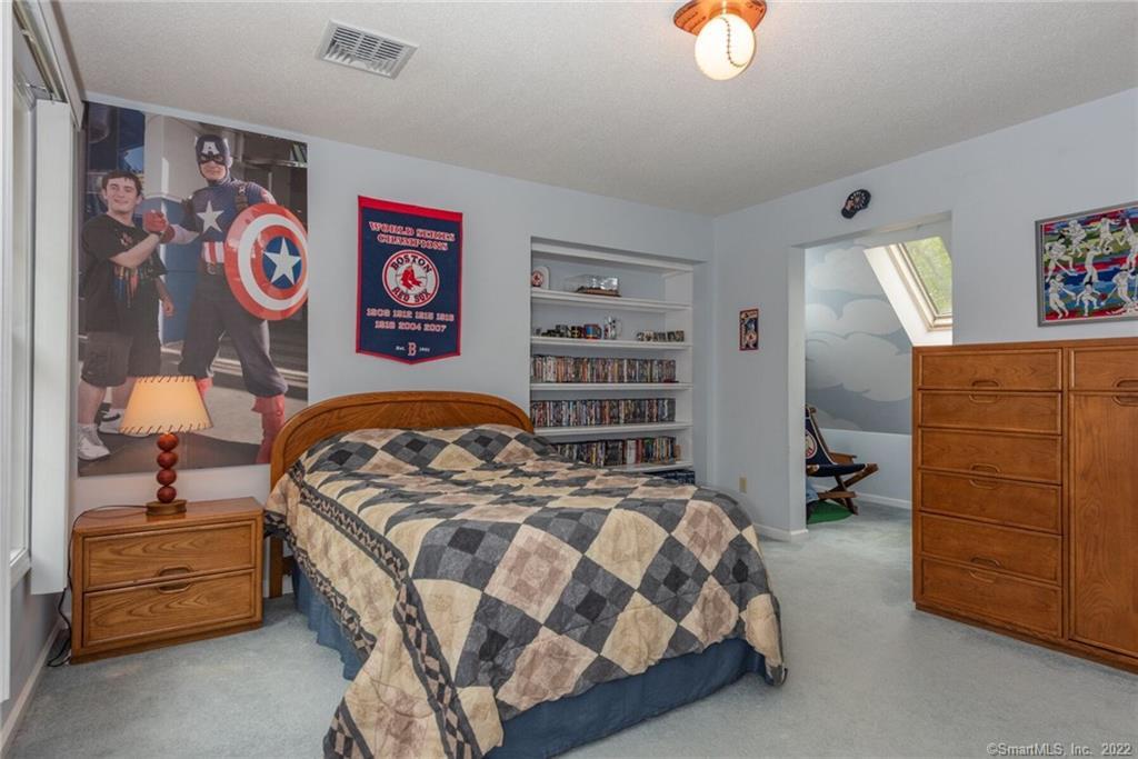 54 Bulkeley Hill Road Colchester, CT 06415 - Photo 31 of 40 a bedroom with a bed and a cabinets