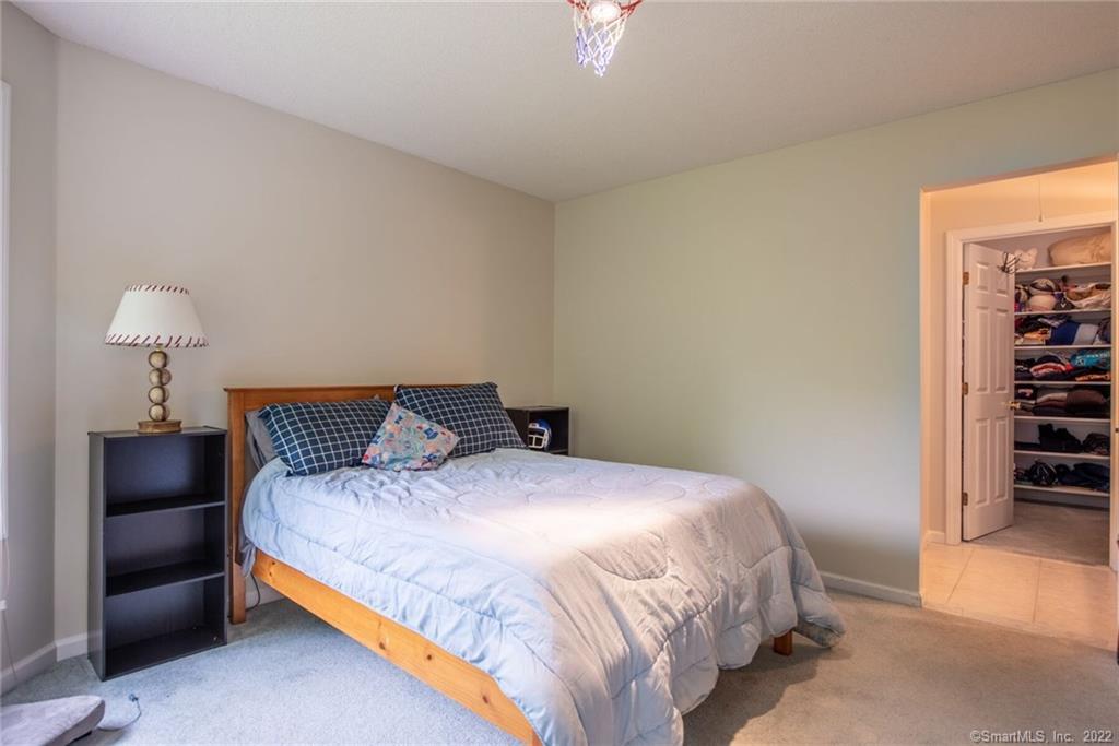 54 Bulkeley Hill Road Colchester, CT 06415 - Photo 33 of 40 a bedroom with a bed and a view of closet