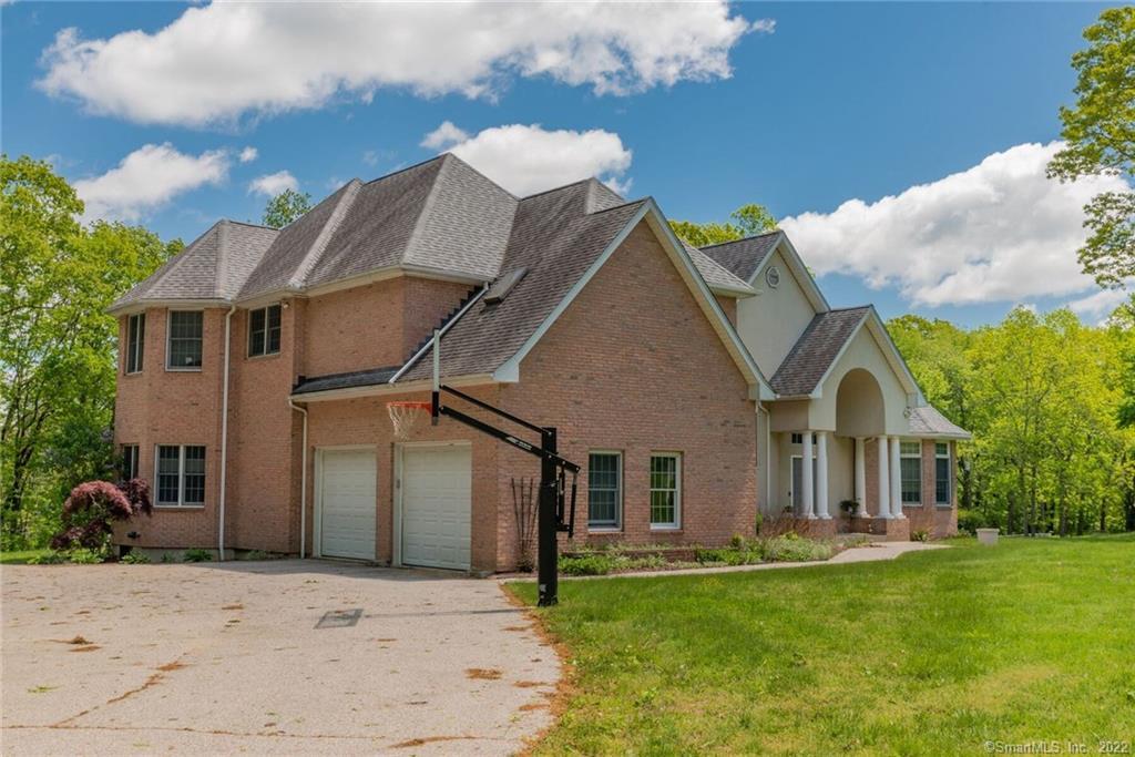 54 Bulkeley Hill Road Colchester, CT 06415 - Photo 4 of 40 a front view of a house with a garden and yard