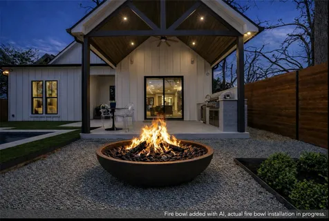 a view of a house with a fire pit and a yard