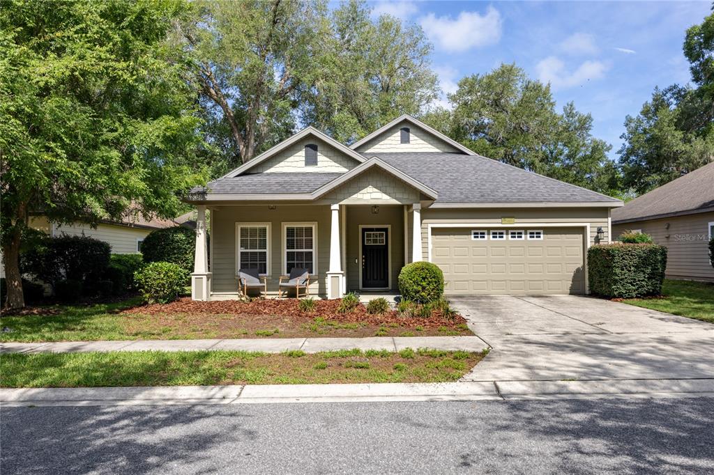 7550 Southwest 81st Way Gainesville, FL 32608 - Photo 1 of 31 a front view of a house with a yard and porch