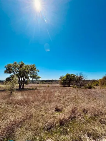 a view of a field with an ocean
