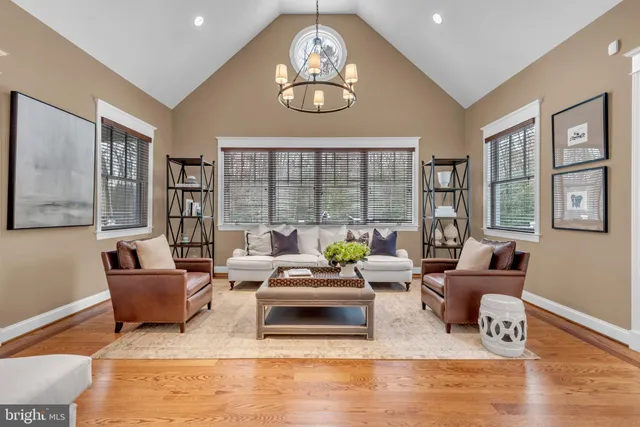 a kitchen with kitchen island granite countertop wooden floors and refrigerator