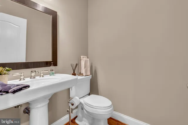 a living room with couches and a wooden floor