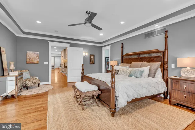 a spacious bedroom with a bed and a table in it