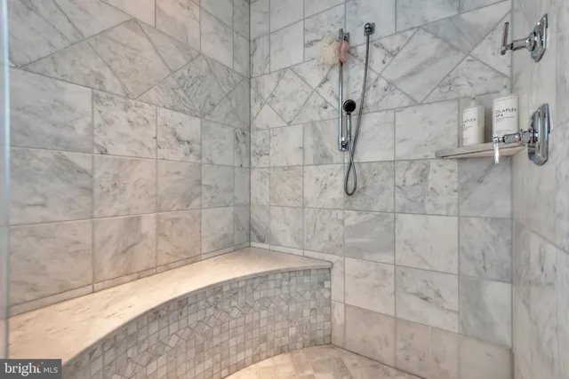 a spacious bedroom with a bed and a chandelier