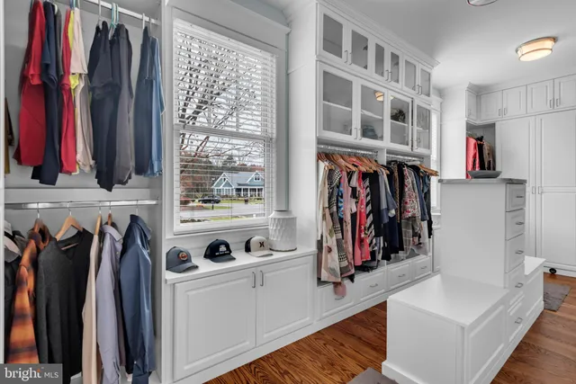 a view of staircase with wooden floor and a large window