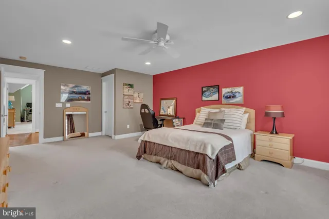 a view of a house with sitting area and wooden bench