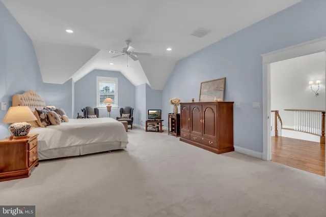 a view of a house with a big yard and large trees