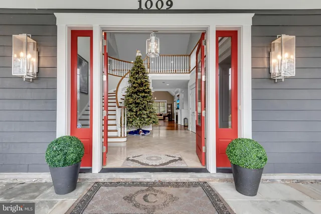 a view of a entryway door of the house and flower pots