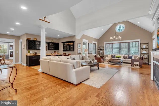 a living room with furniture fireplace and a large window