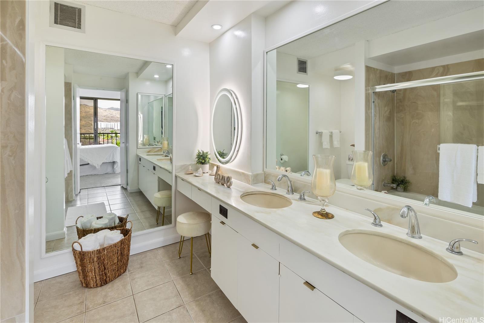 500 Lunalilo Home Road, Unit 16G Honolulu, HI 96825 - Photo 11 of 25 a bathroom with a double vanity sink a mirror and a bathtub