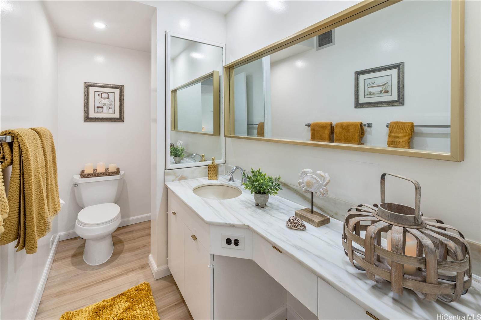 500 Lunalilo Home Road, Unit 16G Honolulu, HI 96825 - Photo 13 of 25 a bathroom with a sink a toilet and mirror