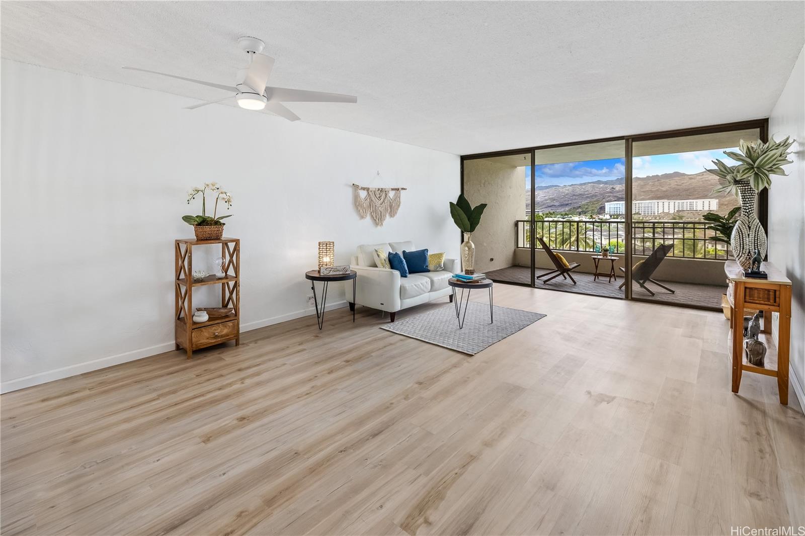500 Lunalilo Home Road, Unit 16G Honolulu, HI 96825 - Photo 5 of 25 a living room with furniture and a floor to ceiling window