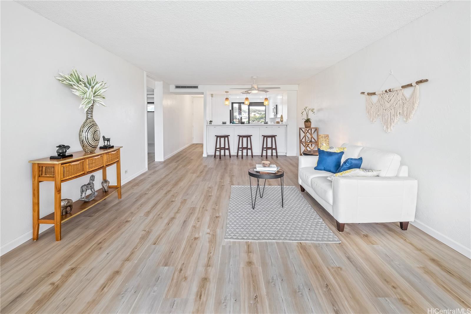 500 Lunalilo Home Road, Unit 16G Honolulu, HI 96825 - Photo 6 of 25 a living room with furniture and a wooden floor