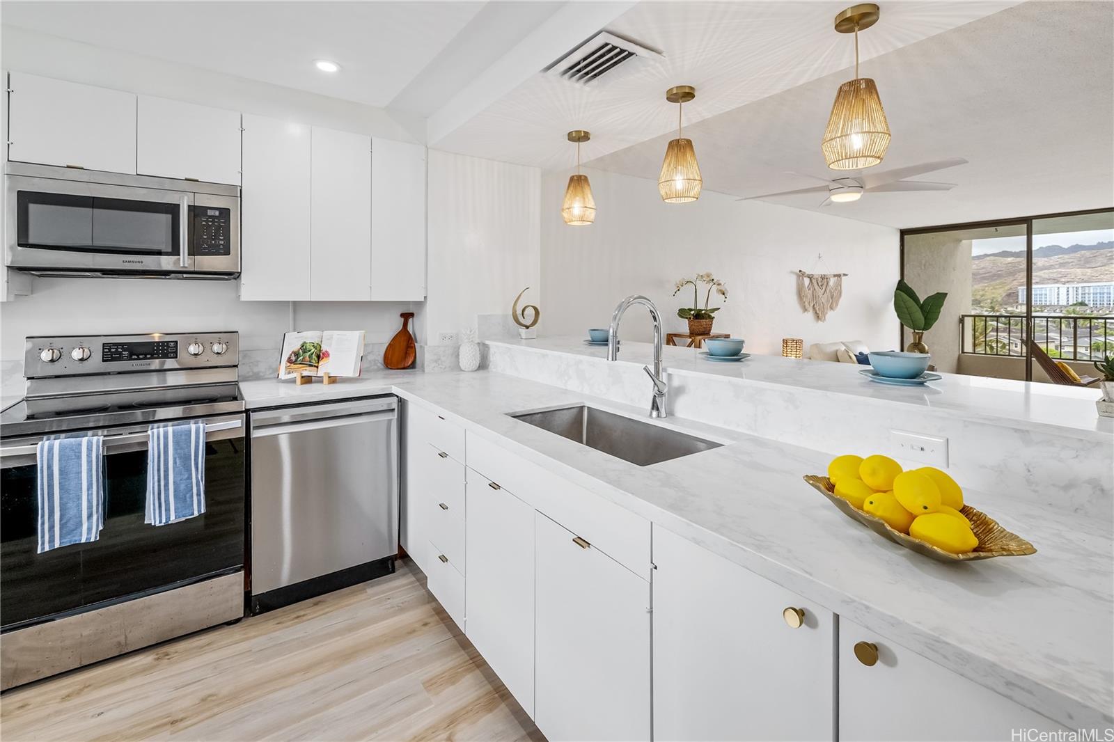 500 Lunalilo Home Road, Unit 16G Honolulu, HI 96825 - Photo 8 of 25 a kitchen with stainless steel appliances a sink a stove and cabinets