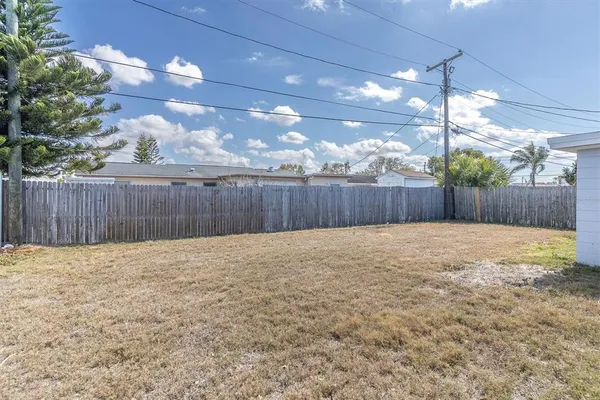 a view of a backyard with wooden fence