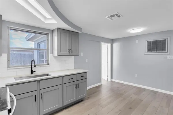 a kitchen with sink and cabinets