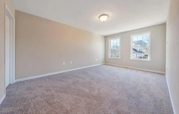 a view of an empty room and a window