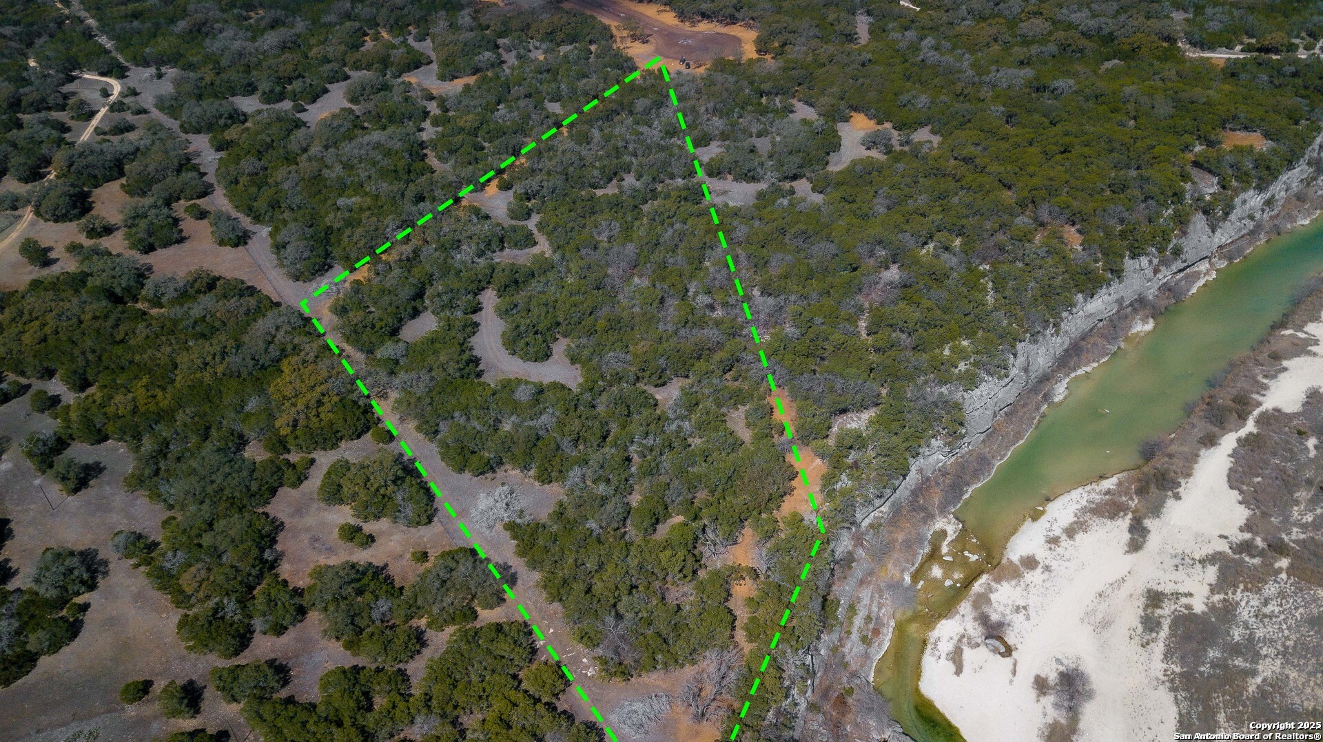 1246 Clearwater Canyon Road Bandera, TX 78003 - Photo 13 of 27 an aerial view of a house with a lake view