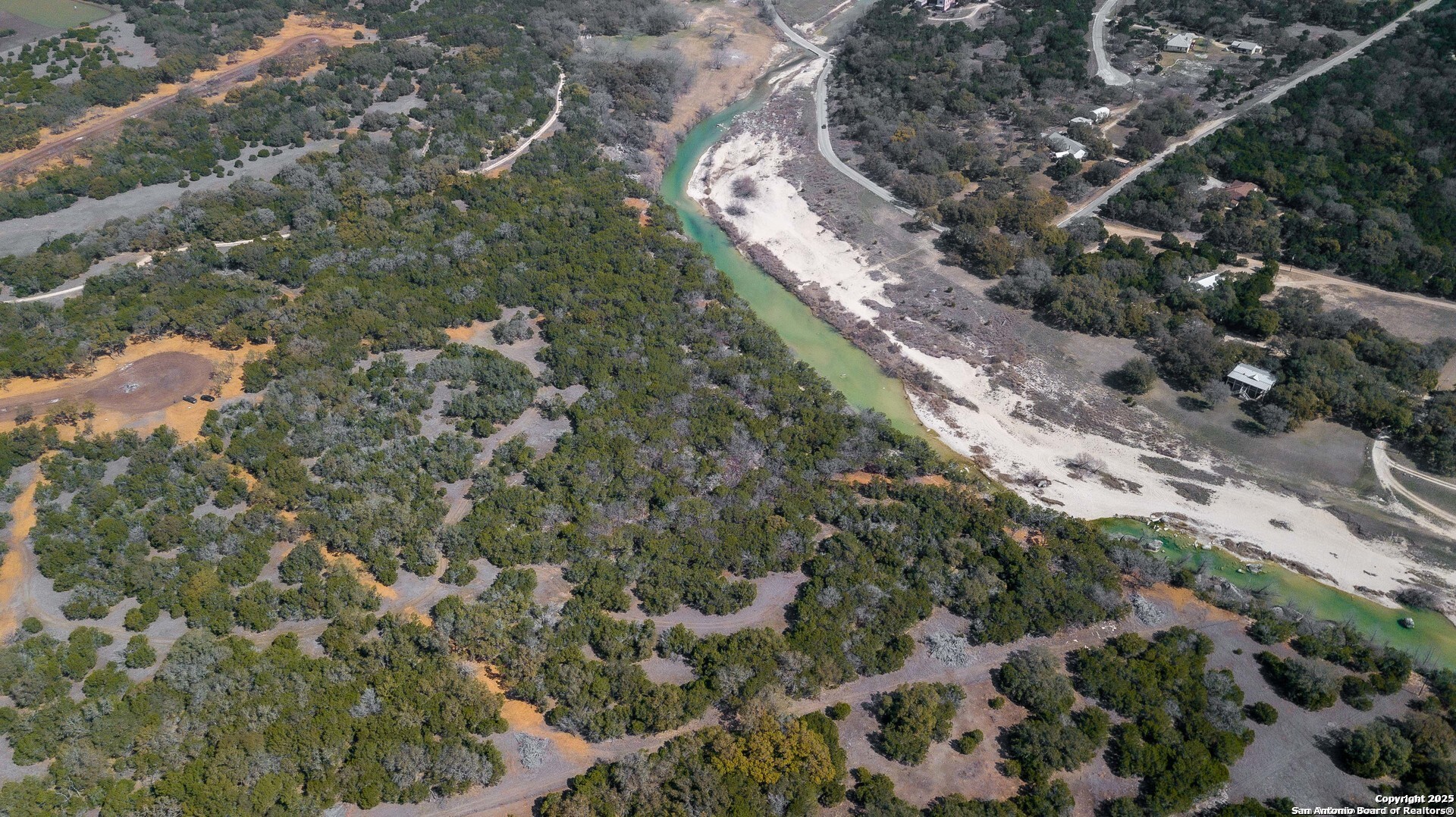 1246 Clearwater Canyon Road Bandera, TX 78003 - Photo 25 of 27 a view of a yard with plants and large trees