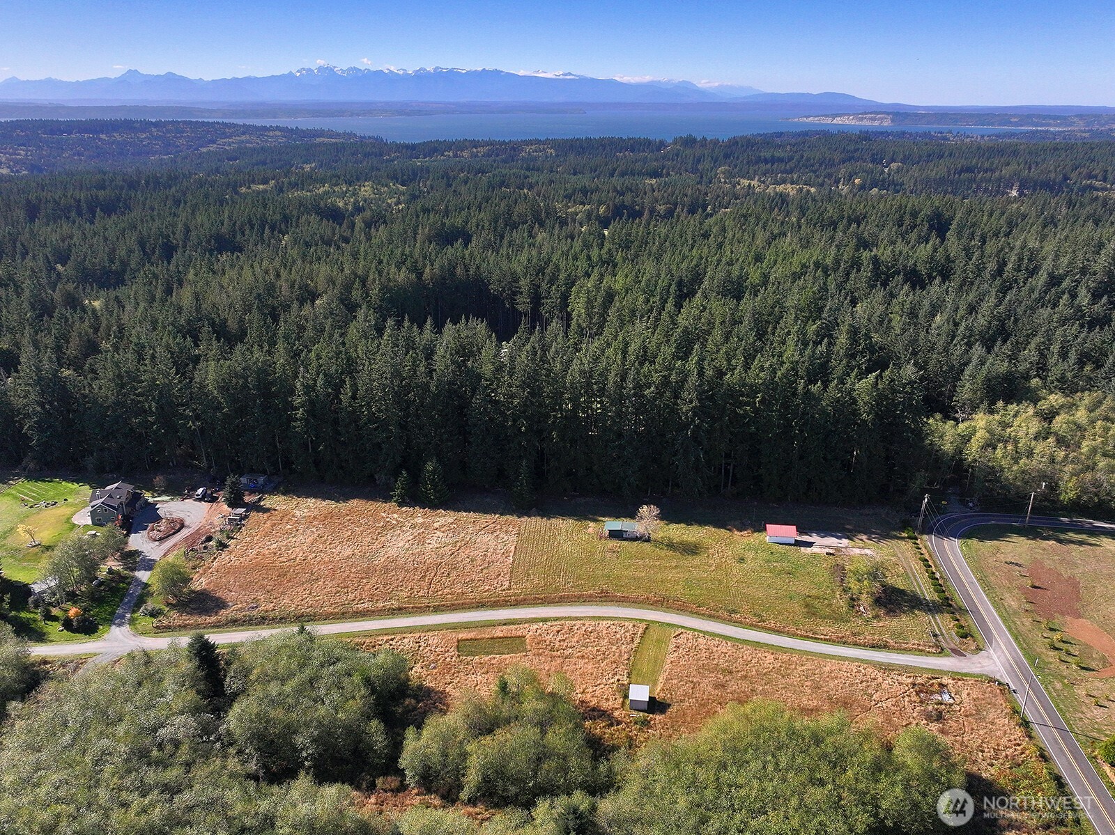 7110 Olin Place Clinton, WA 98236 - Photo 4 of 12 a view of a swimming pool with a yard