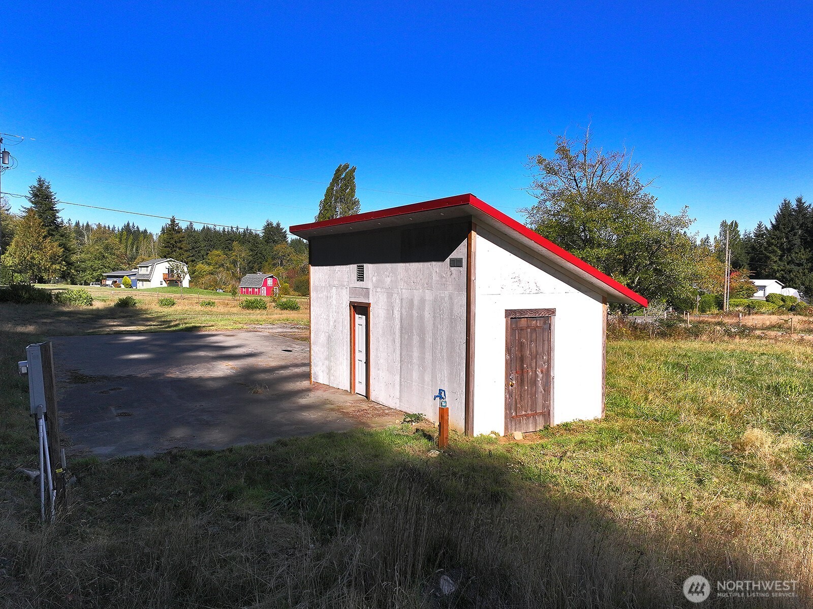 7110 Olin Place Clinton, WA 98236 - Photo 9 of 12 a view of backyard of house and car parked