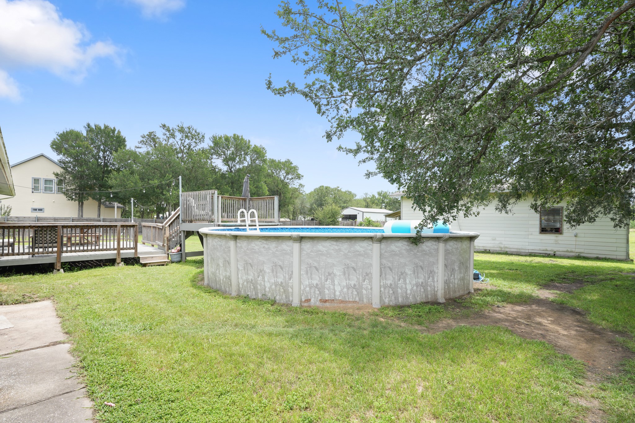 9725 Bock Road Buda, TX 78610 - Photo 28 of 32 An above-ground pool and wood deck create an ideal backyard for outdoor enjoyment.
