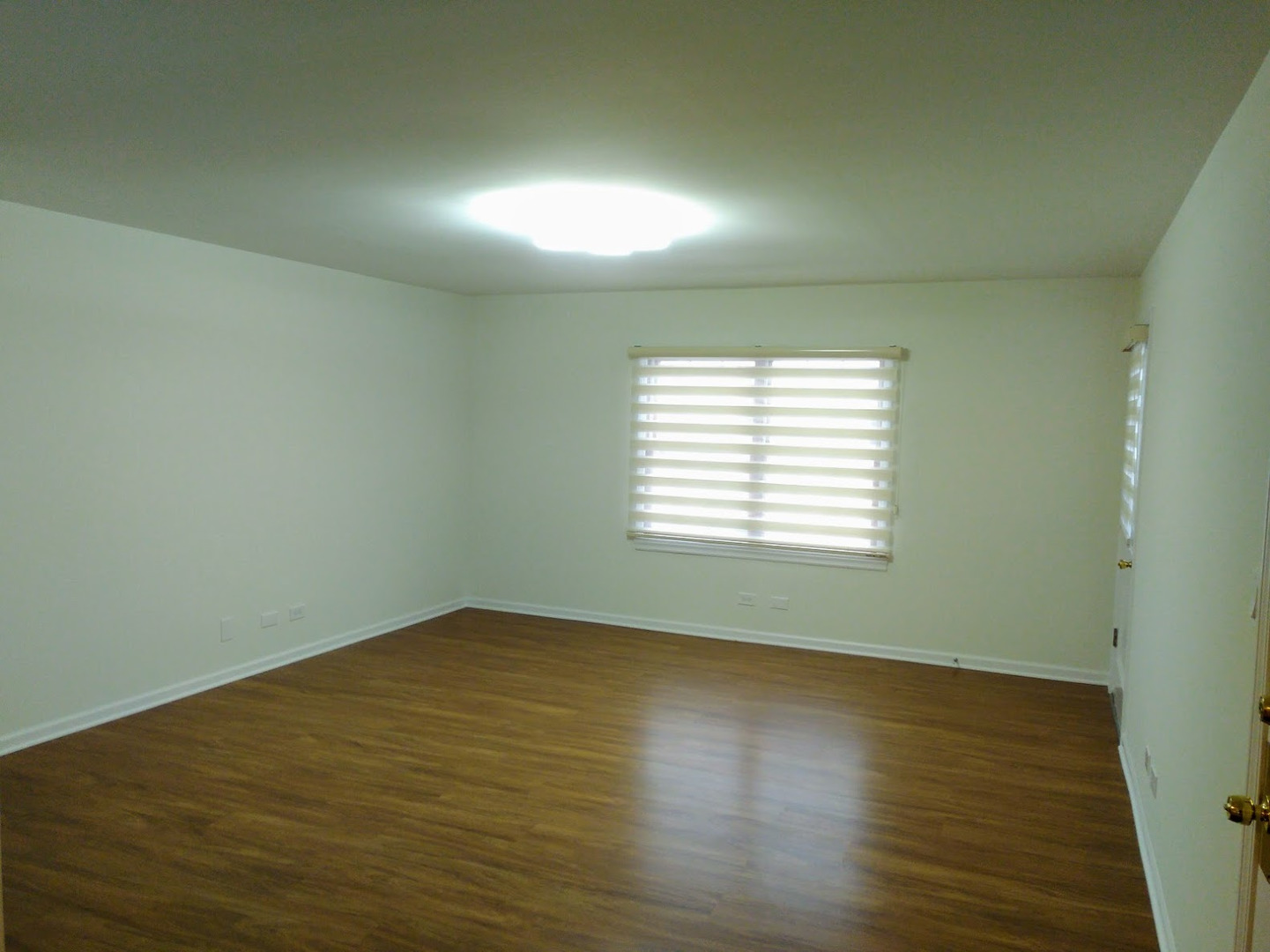 2822 Dundee Road, Unit 13B Northbrook, IL 60062 - Photo 2 of 10 an empty room with wooden floor and windows