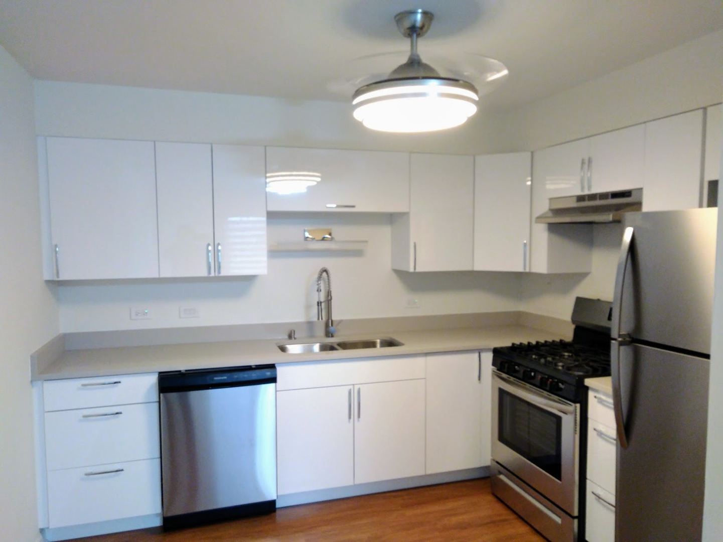 2822 Dundee Road, Unit 13B Northbrook, IL 60062 - Photo 4 of 10 a kitchen with white cabinets stainless steel appliances and sink
