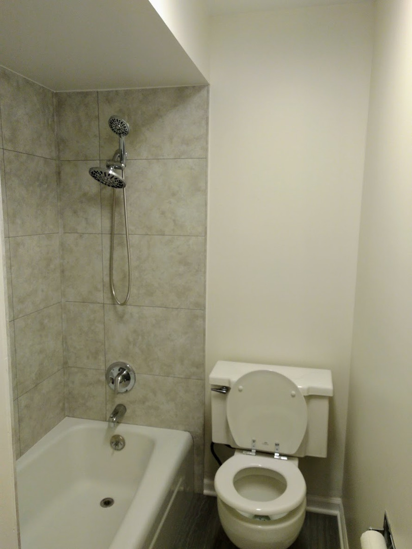 2822 Dundee Road, Unit 13B Northbrook, IL 60062 - Photo 9 of 10 a white toilet sitting next to a bath tub