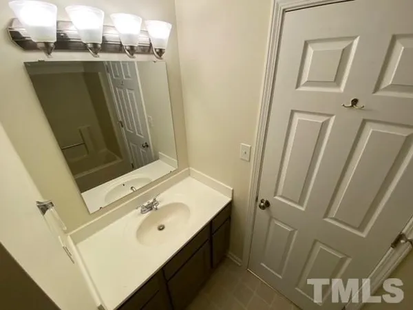 a bathroom with a sink a toilet a mirror and vanity