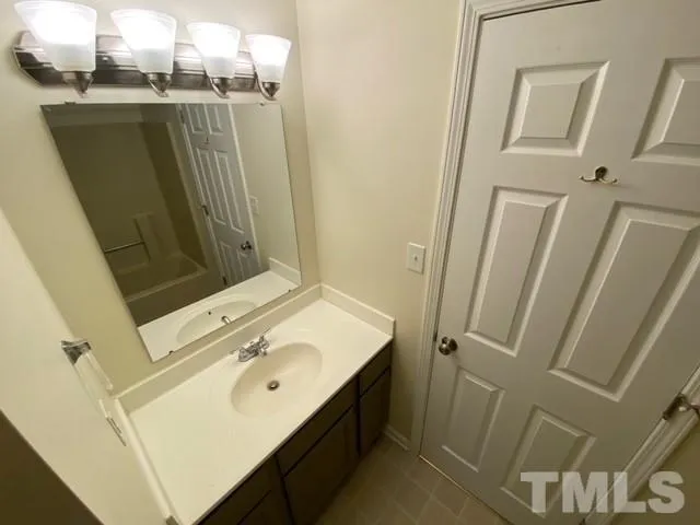 a bathroom with a sink a toilet a mirror and vanity