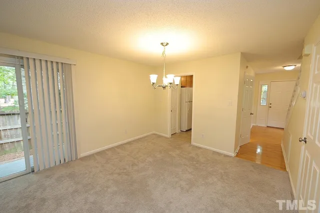 a view of an empty room with a fireplace