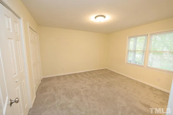 an empty room with a empty space and windows