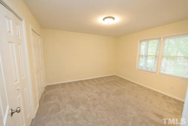 an empty room with a empty space and windows